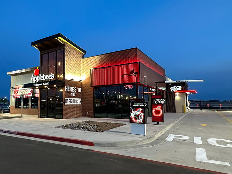 Modern style Applebee's budlding with pickup lane lit up in front during twilight 